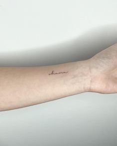 a person's arm with a small tattoo on it that says, i love you