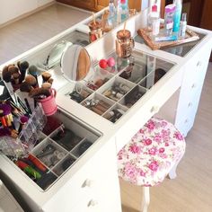 a vanity with drawers and makeup on it