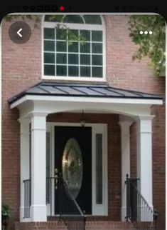 a house with a black door and white trim