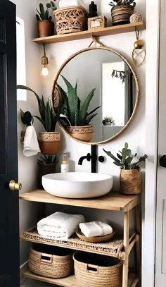 a white sink sitting under a mirror next to a shelf filled with potted plants