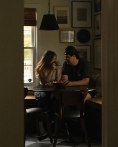 a man and woman sitting at a table