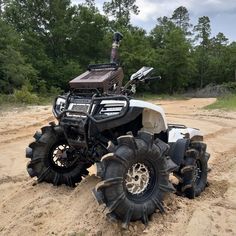 a four - wheeler parked in the middle of a dirt road