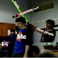 a young man holding a baseball bat in a room with other people behind him and the words me on it