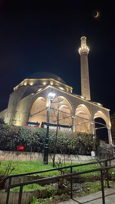 a large building with a clock tower at night