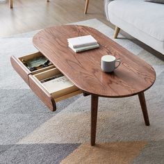 a coffee table with an open drawer in the middle on carpeted floor next to couch