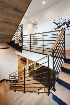 an open staircase leading up to the second floor in a modern home with wood floors and white walls