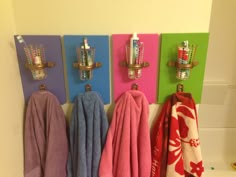 towels and toothbrushes are hanging on the wall