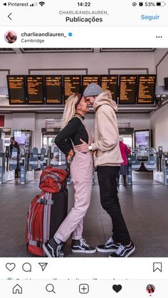 two people standing next to each other in an airport