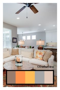 a living room filled with furniture and a ceiling fan in the middle of it's walls