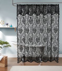 a black and white shower curtain hanging on a bathroom wall next to a bathtub