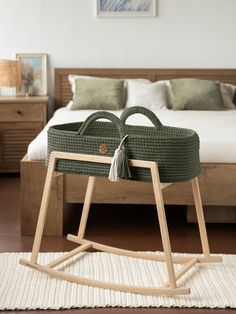 a bed with a wooden frame and green wicker basket on top of the sleigh