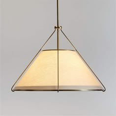 a light hanging from a ceiling fixture with a white shade on the top and bottom