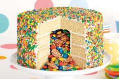 a birthday cake with sprinkles and candy on the top is shown in this advertisement