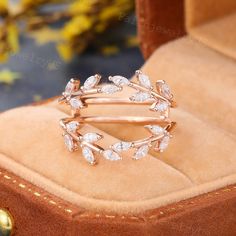 a close up of a ring with diamonds on the inside of it in a box