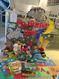 there are many stuffed animals and books on the table in front of this sign that says prama's day