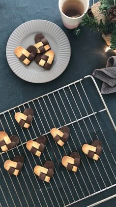 chocolate and marshmallows on a cooling rack next to a cup of coffee