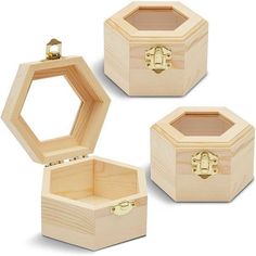 three wooden boxes with gold handles on each one and an open box in the middle