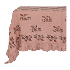 a pink table cloth with red flowers on it