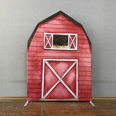 a painting of a red barn with a black cat in it's window on the floor