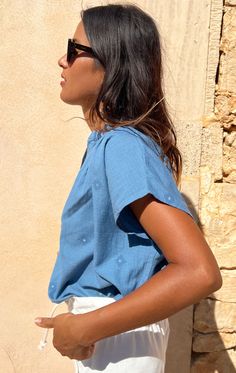 Our Signature shirt in a gorgeous chambray with tone on tone blue woven details with metallic dot . Easy to wear from beach to city. We promise this top will be your go-to warm weather item. Perfect under a blazer. Opaque weight and truly a special fabric. This Handwoven Fabric is custom designed by Two. Color: Medium Indigo Summer Workwear Shirt, Chic Cotton Light Indigo Top, Chic Light Indigo Cotton Tops, Light Indigo Relaxed Fit Cotton Blouse, Light Indigo Cotton Blouse With Relaxed Fit, Indigo Cotton Tops For Day Out, Light Indigo Cotton Blouse For Summer, Summer Light Indigo Cotton Blouse, Indigo Linen Summer Tops