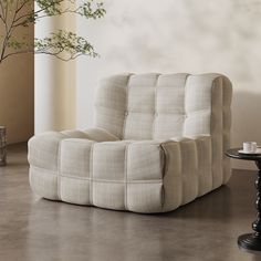 a white couch sitting on top of a floor next to a table