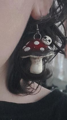 a close up of a person wearing a necklace with a mushroom on it