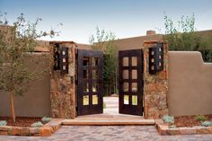 an entrance to a home with stone walls and doors