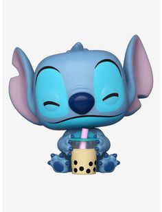 the pop vinyl figure is sitting next to a cup