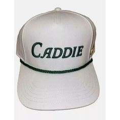 a white cap with the word caddie on it's front and green cord