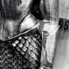 a close up of a metal statue wearing armor