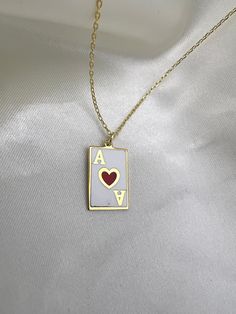 ENAMELED ACE OF HEARTS NECKLACE      Material: High Quality Solid 925 Sterling Silver Finish: Silver, Gold ♡ The most unique jewelry you can find, perfect gift for you and your loved one. ♡ All of our jewelry is handcrafted with enthusiasm and great care in our workshop. ► HOW TO CARE FOR YOUR JEWELRY * Maintain your jewelry high shine by avoiding contact with any chemicals such as hand soap, perfume, lotion, makeup, hair & cleaning products. * Keeping your jewelry in a pouch or a box after using it will prolong the life of your jewelry. * Not recommended for sensitive and allergic skin. * You can do your product maintenance with a cotton-soft dry cloth. * You can keep it in the pouch sent together. ► ADDITIONAL INFO * Please check the announcements section of our homepage to get more disc Enamel Necklaces For Anniversary On Valentine's Day, Ace Jewelry, Card Necklace, Ace Earrings, Ace Heart Card, Valentine's Day Gift Enamel Charm Necklace, Ace Of Hearts Necklace, Valentine's Day Gift Enamel Charm Necklaces, Necklaces On Playing Cards