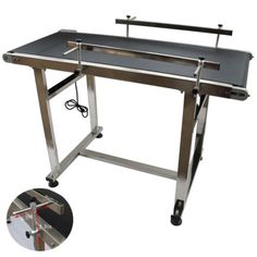 an image of a metal workbench with wheels and handlebars on it