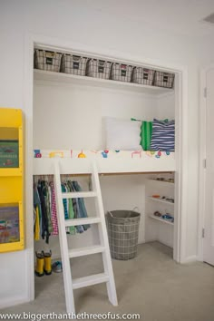 a white bunk bed sitting next to a yellow shelf filled with books and other items