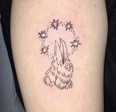 a small rabbit tattoo on the right thigh and upper leg, with stars in the background