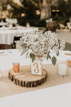 the table is set with flowers and candles