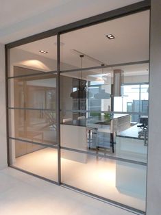 an office with glass walls and desks