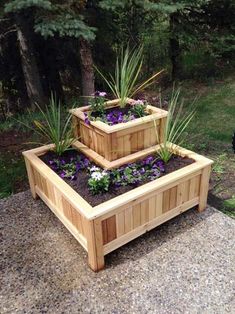 three wooden planters with purple flowers in them