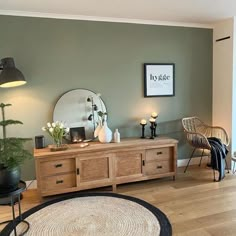 a living room filled with furniture and a large mirror on top of a wooden table