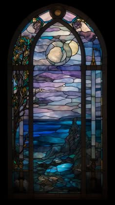 a stained glass window with water and clouds