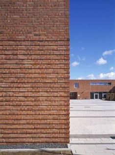 a tall brick building sitting next to a parking lot