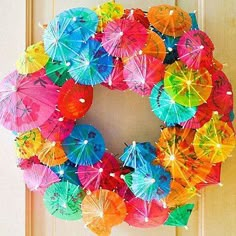 a wreath made out of umbrellas hanging on a door