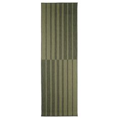 a green rug with vertical stripes on it