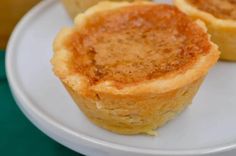 three mini cheesecakes on a white plate