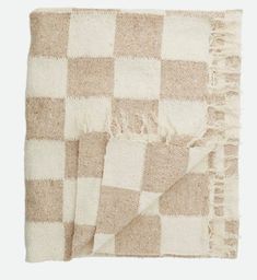 the checkered blanket is tan and white