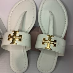 Gold Logo With White Leather Material Sz 7 Elegant Leather Flip Flops For Vacation, Elegant Leather Flip Flops With Branded Insole, Designer Sandals With Gold-tone Hardware, Chic Adjustable Leather Flip Flops, Luxury Tan Sandals With Leather Footbed, Elegant Tan Sandals With Leather Lining, Luxury Leather Flip Flops With Single Toe Strap, Luxury Leather Open Toe Flip Flops, Tan Leather Open Toe Flip Flops