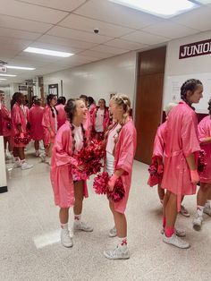 the girls are dressed in pink robes and cheerleaders