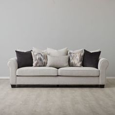 a white couch with black and grey pillows