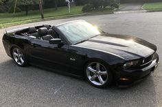 a black sports car is parked on the street