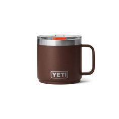 the yeti coffee mug is brown and has a stainless steel lid with an orange handle