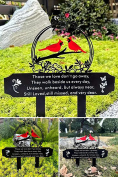 two red birds sitting on top of a wooden sign in the middle of some grass